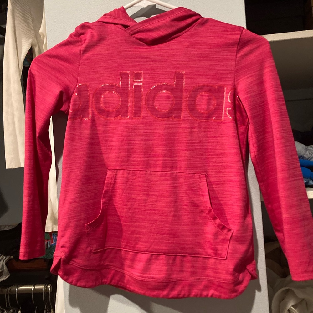 It is a barely worn pink adidas long sleeve shirt with a hood size is 7-8